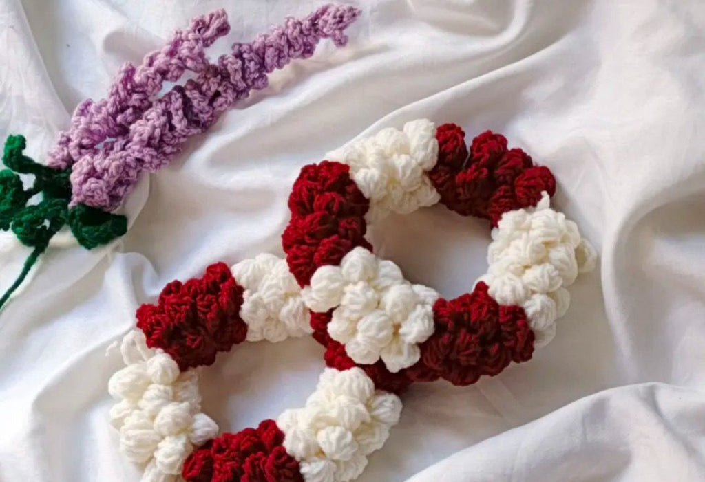 Authentic Kashmiri handmade red and white crochet rose scrunchie set with lavender crochet flower on white fabric background Pakistan