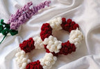 Authentic Kashmiri handmade red and white crochet rose scrunchie set with lavender crochet flower on white fabric background Pakistan