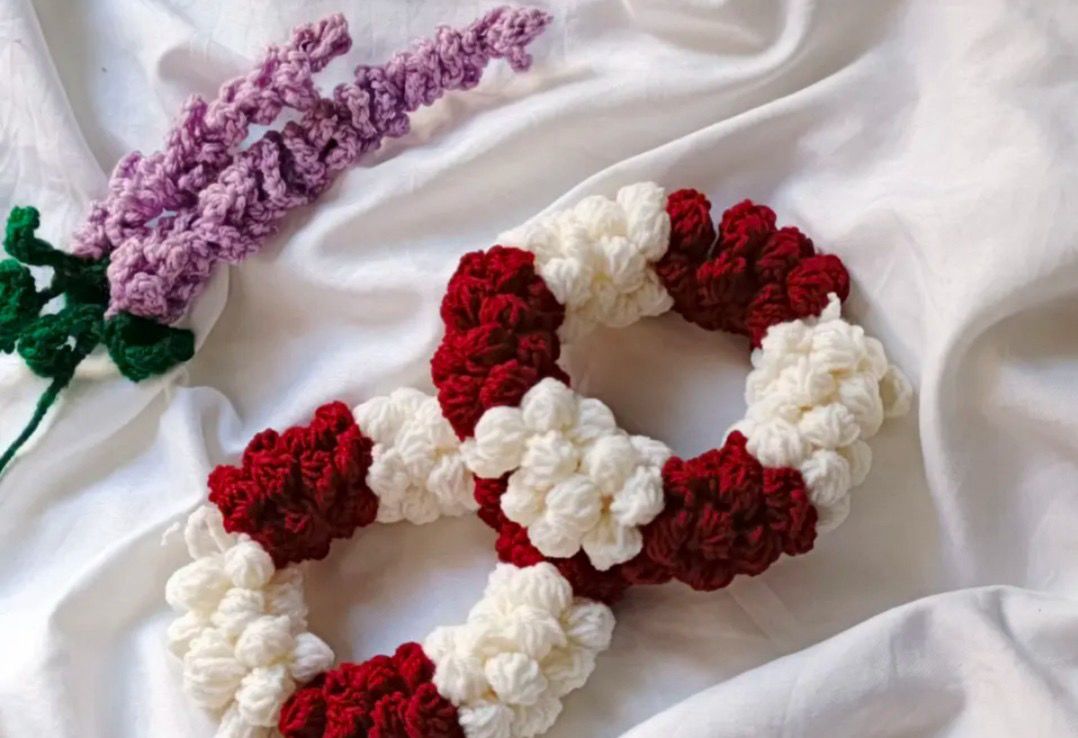 Authentic Kashmiri handmade red and white crochet rose scrunchie set with lavender crochet flower on white fabric background Pakistan