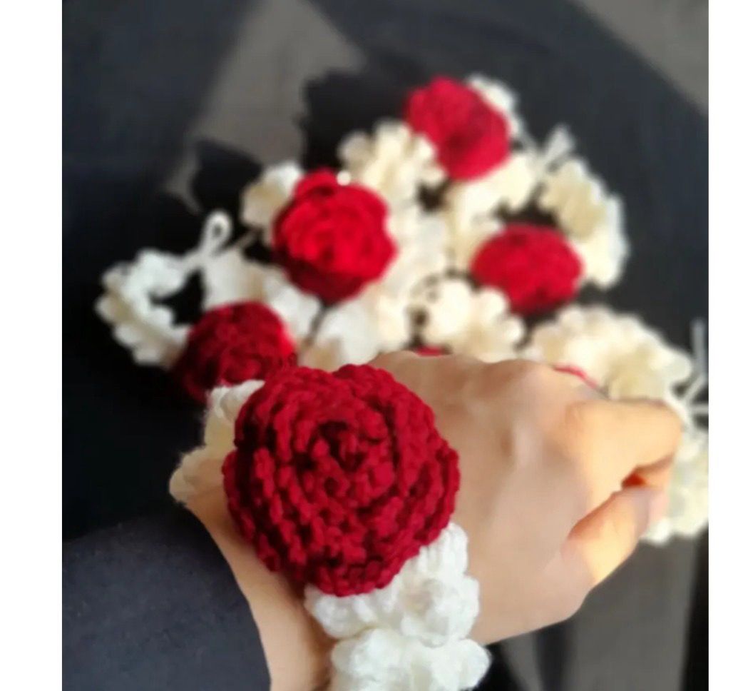 Girl holding authentic Kashmiri handmade red crochet rose bracelet and white scrunchie set close up artisan crafted accessory Pakistan