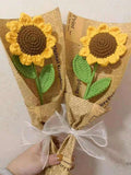 A beautiful Kashmiri handmade crochet sunflower bouquet wrapped in vintage newspaper print with a white bow.